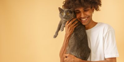 HOMEM COM GATO NO COLO