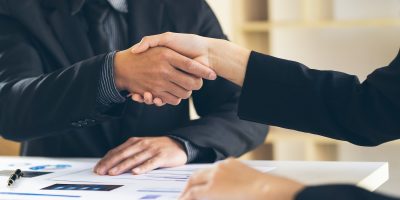Close up view of business partnership handshake.Concept two businessman handshaking process.Success