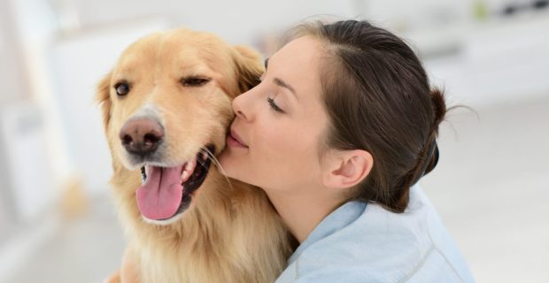 Young woman petting her dog