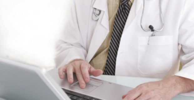 Doctor working on a notebook computer.