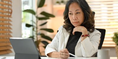 Smart professional senior business woman watching business training.