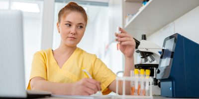 Woman vet sitting at desk in animal clinic