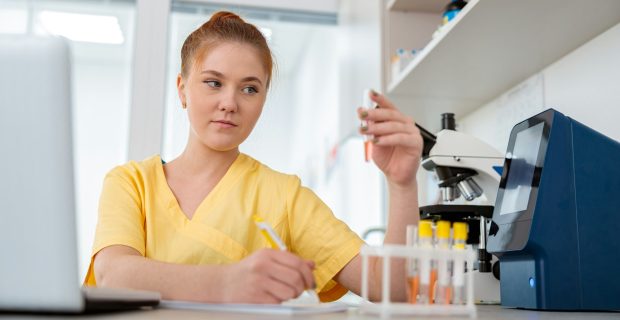 Woman vet sitting at desk in animal clinic
