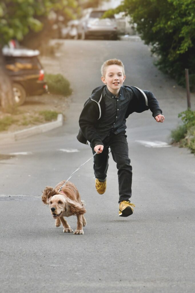 Happy kid running with his dog