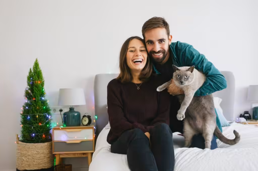 Portrait of couple and their cat at home