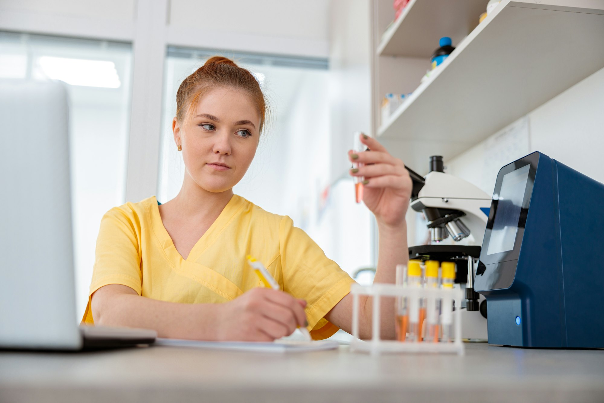 Woman vet sitting at desk in animal clinic